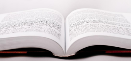 Encyclopedia laid open, displaying text on pages.